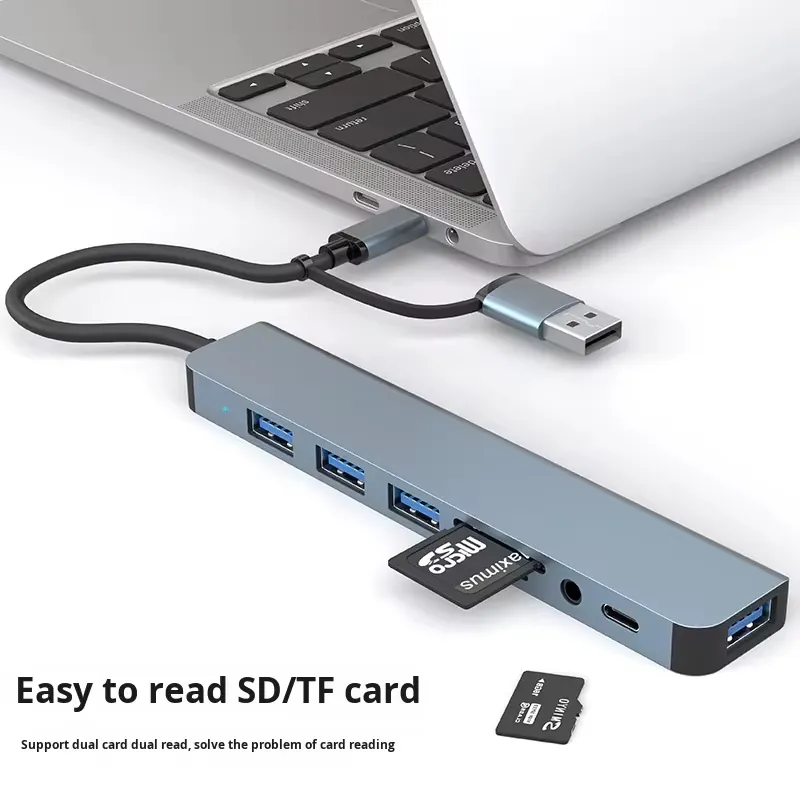 Dual-head 8-in-1 aluminium USB-C hub connected to a laptop with SD and TF card reading cue