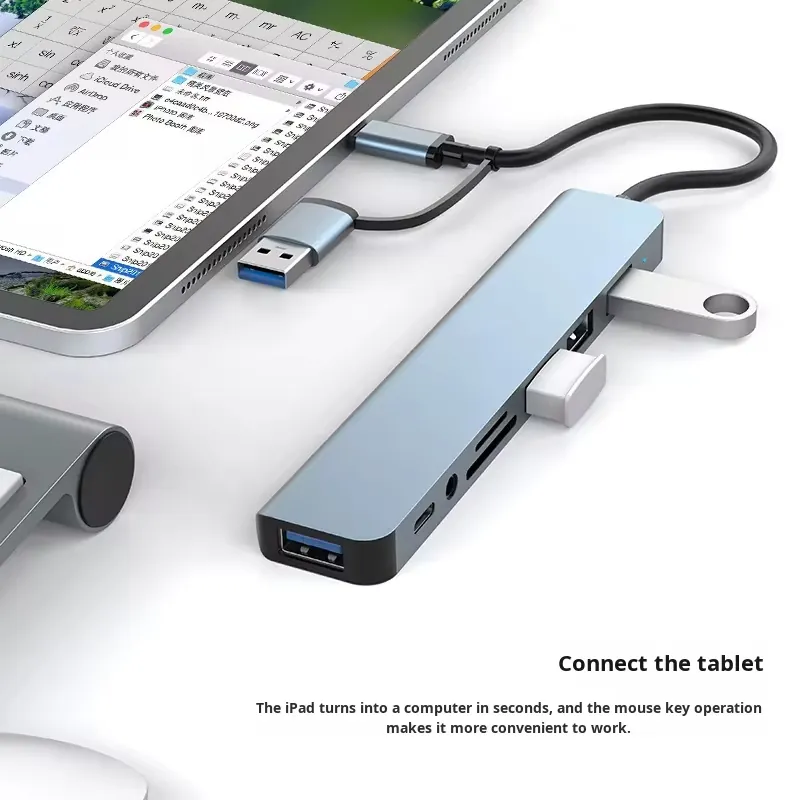 Dual-head 8-in-1 aluminium USB-C hub connected to a tablet with USB flash drives and peripherals