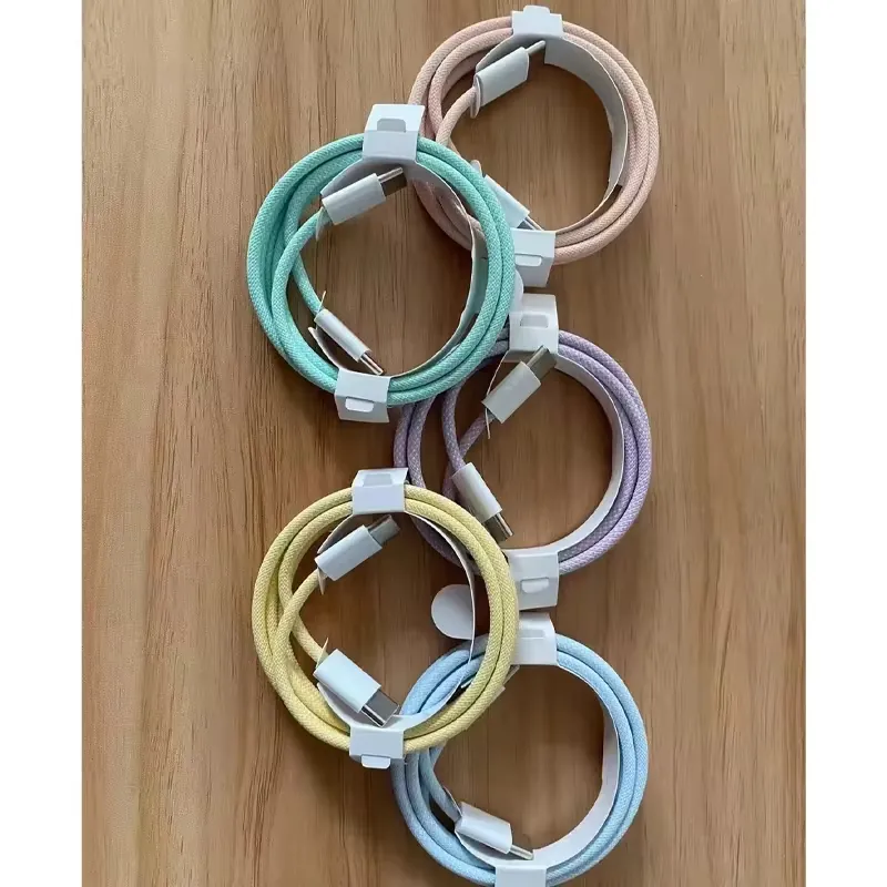 Coiled braided USB-C to USB-C cable color set arranged on a wood surface
